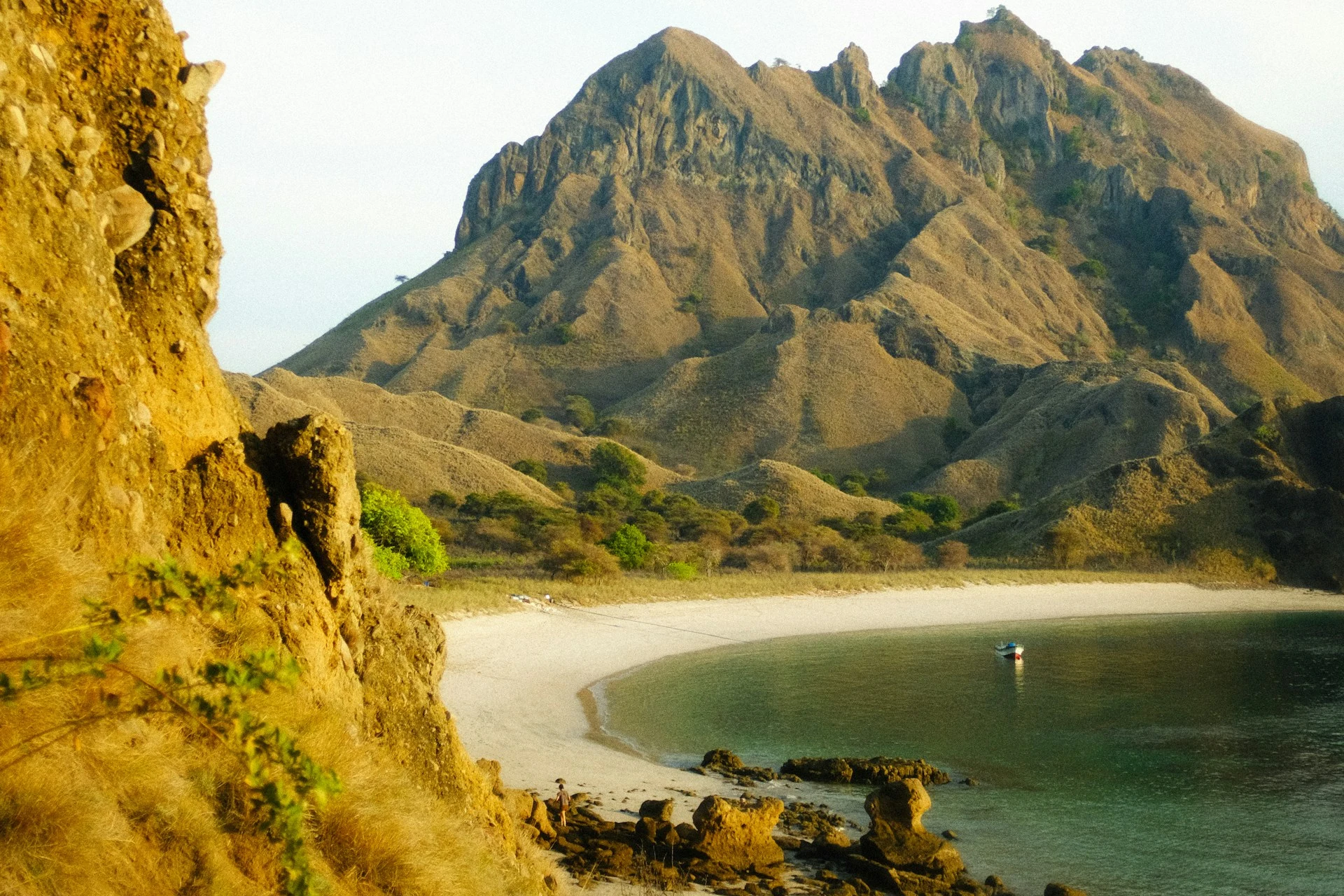 Golden ridgelines above a curved beach on Padar Island