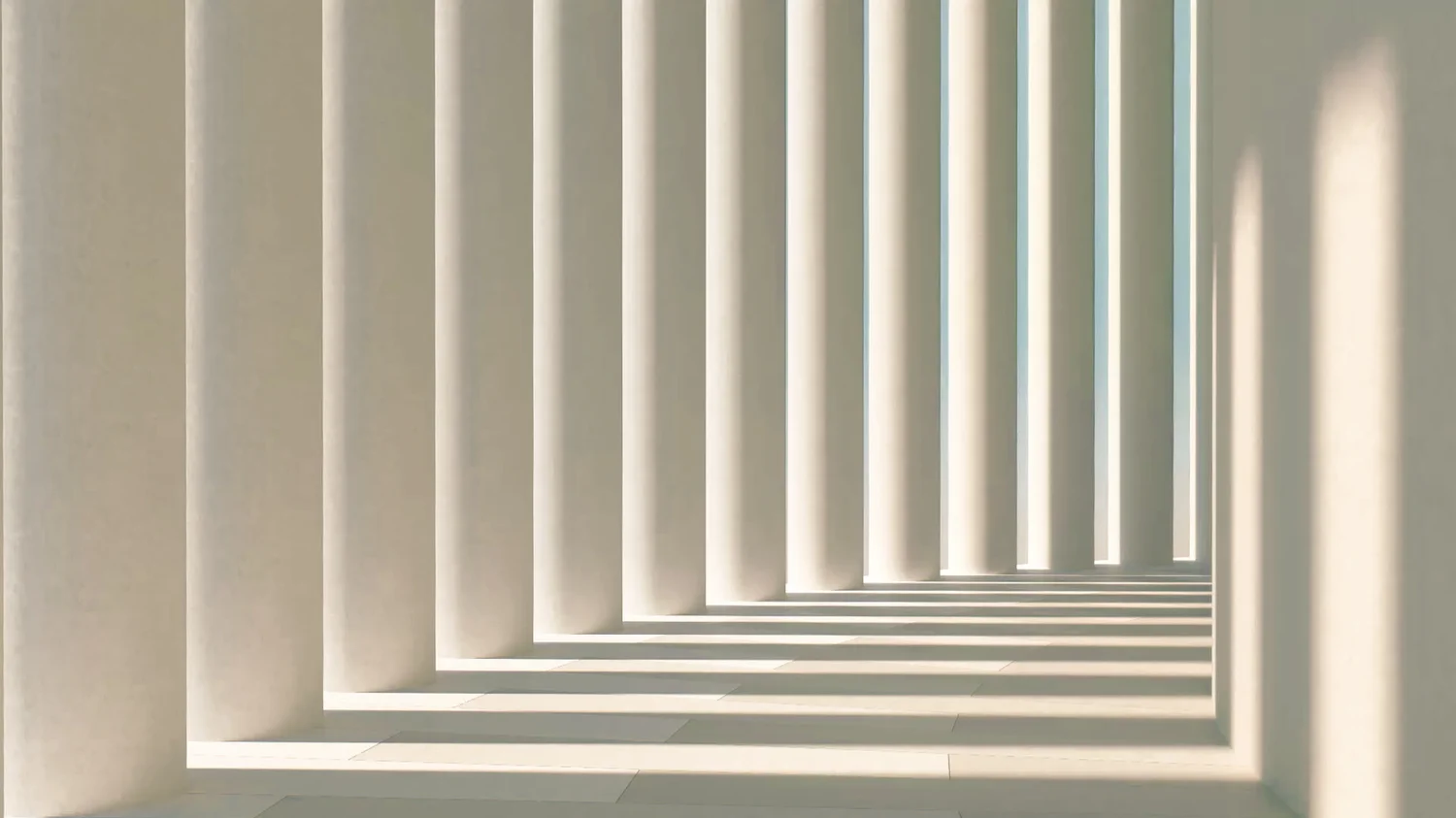 A light-filled architectural passage with sculptural columns