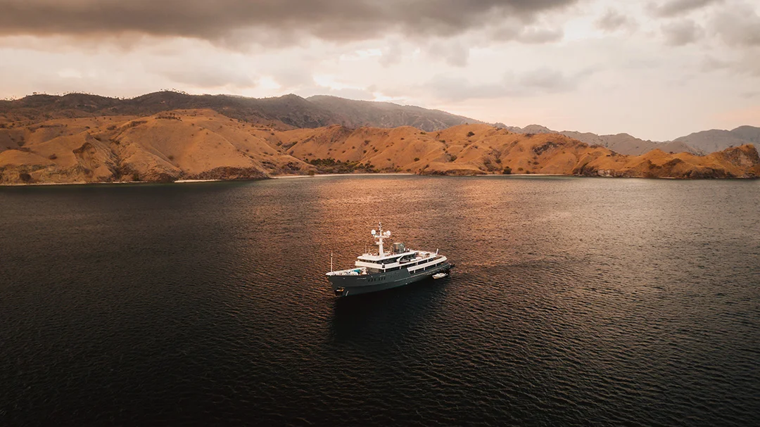 A private yacht anchored beside an Indonesian island